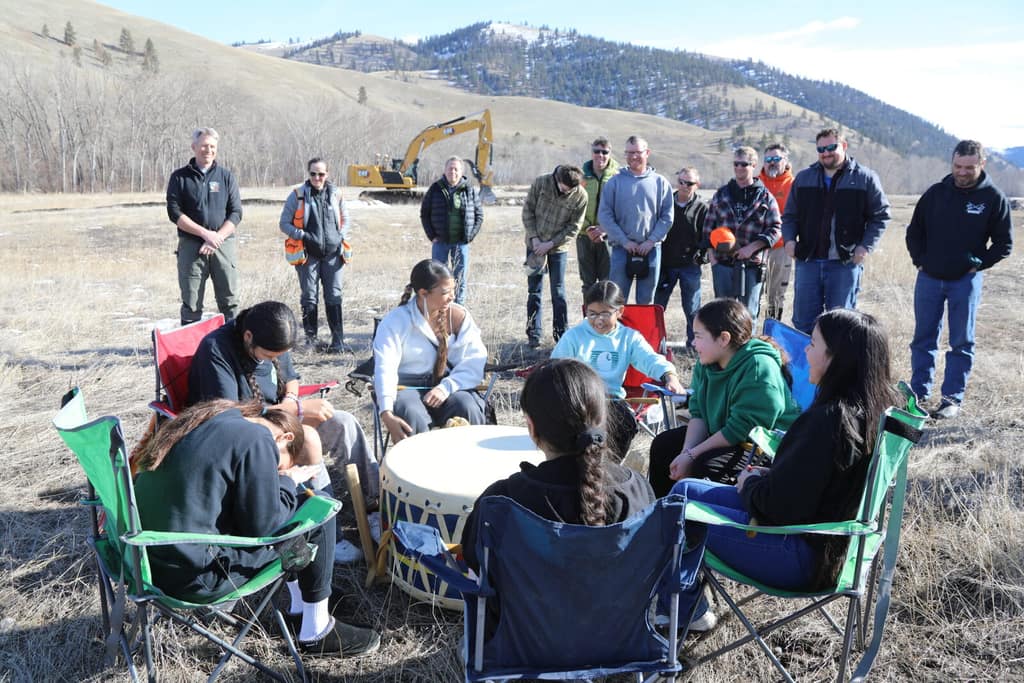 Community members gathered in a circle at the Jocko Bison Range Reach groundbreaking