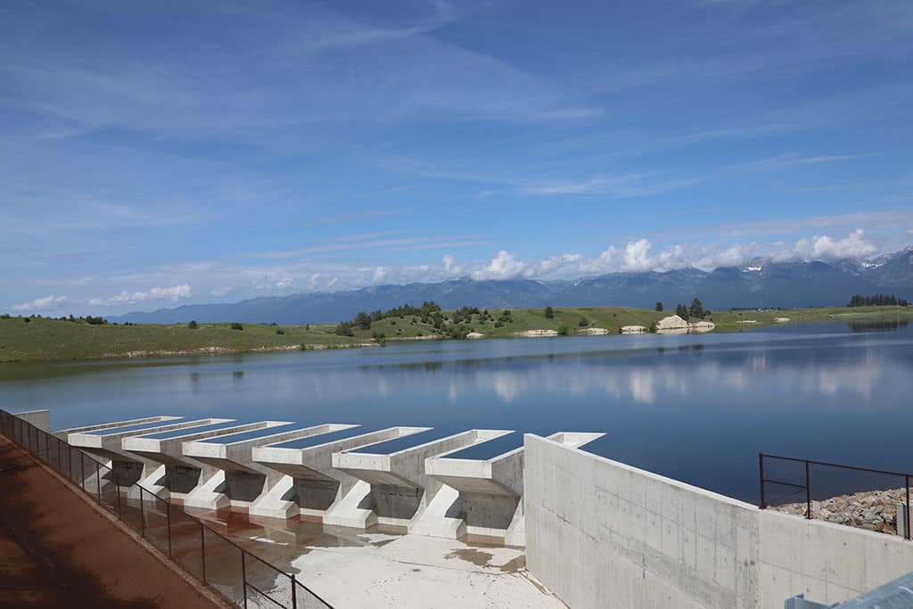 The completed Crow Dam spillway crest beside Lower Crow Reservoir