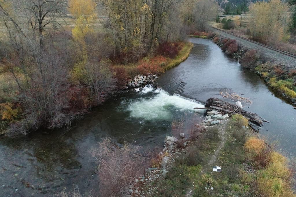 Aerial view of the Jocko River bending through autumn cottonwoods