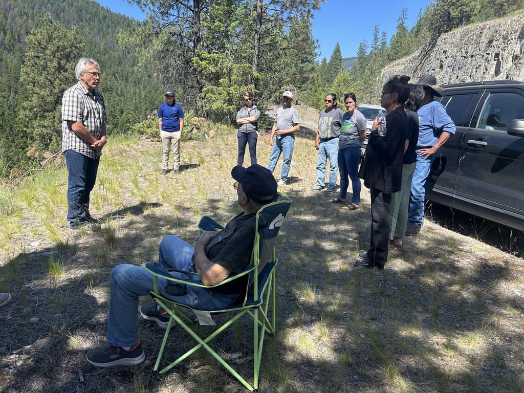Elders and staff talking at an outdoor site visit